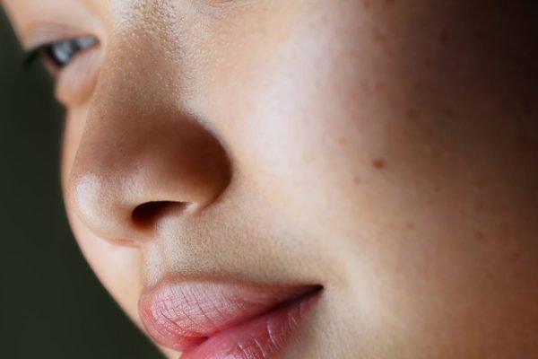 Close-up portrait of young asian female with smooth skin and soft expression.